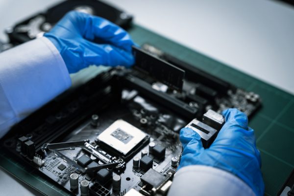 killed hands repairing electronic devices with precision. technology repair, technician expertise, and modern electronic maintenance.